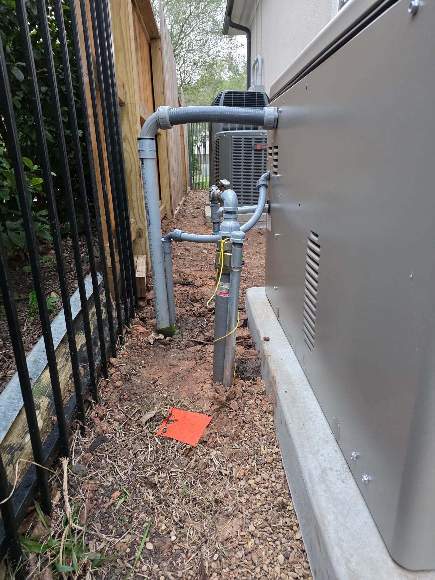 Gas supply piping and regulator run into a completed standby generator installation