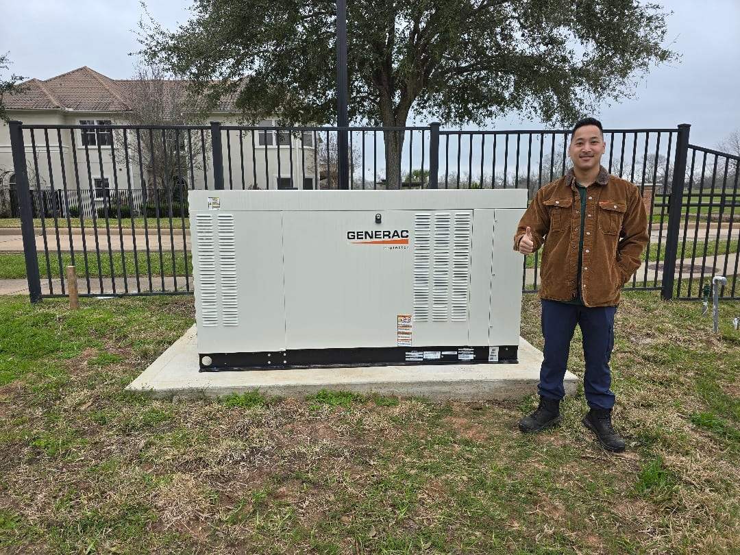 A Critical Power Solutions owner on site beside a commercial Generac standby generator