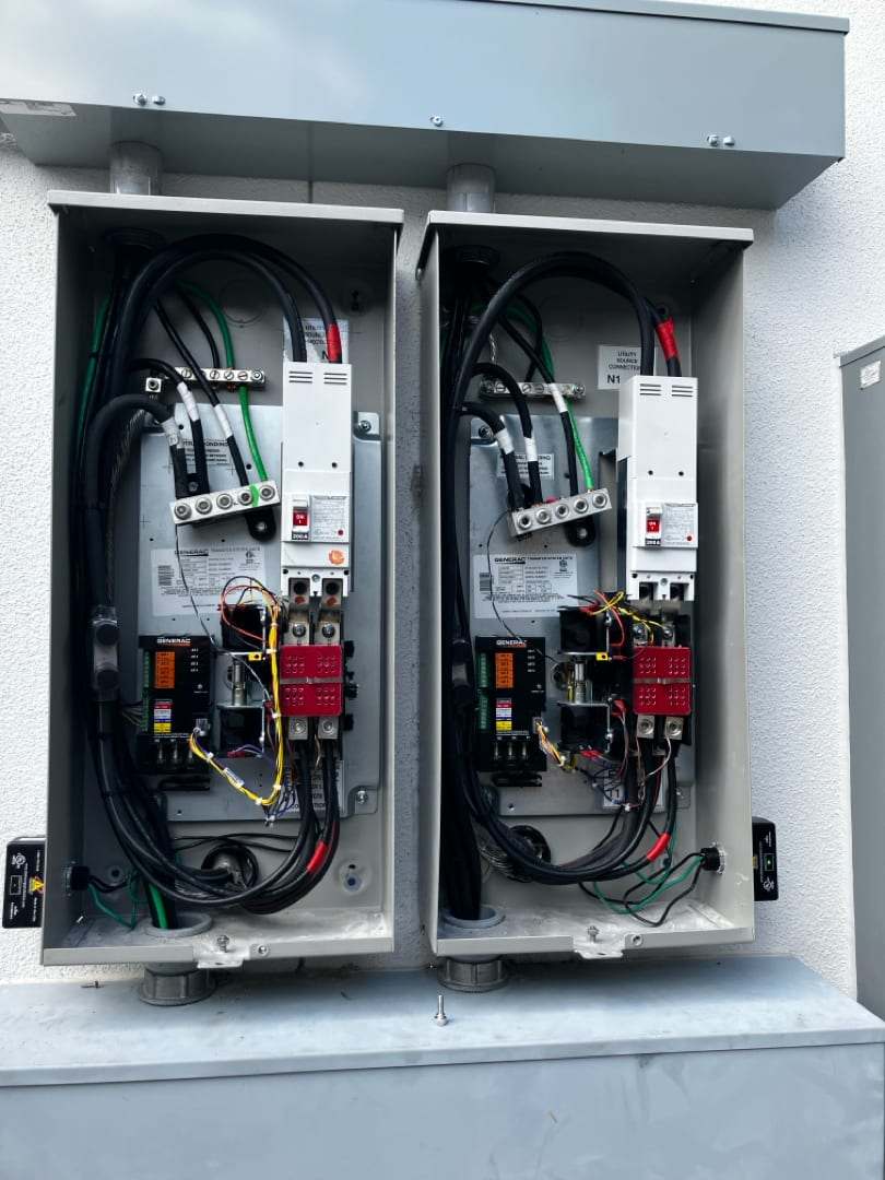 A bank of automatic transfer switches wired out with the doors open