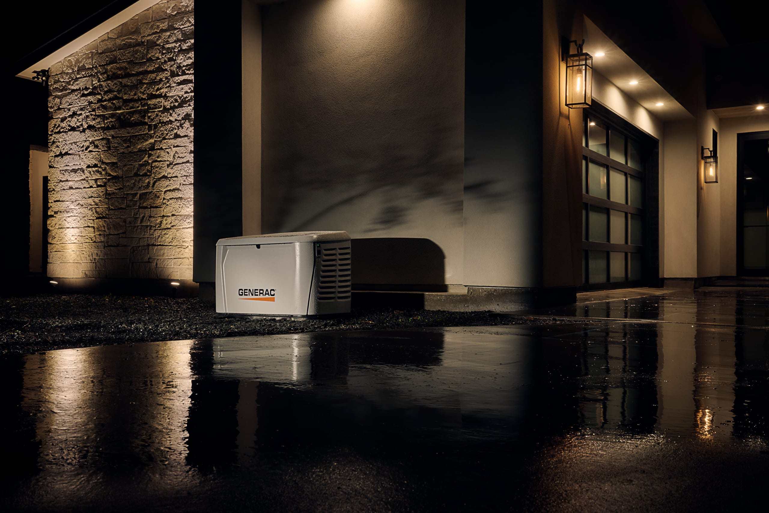 A standby generator running at night beside a home after a storm